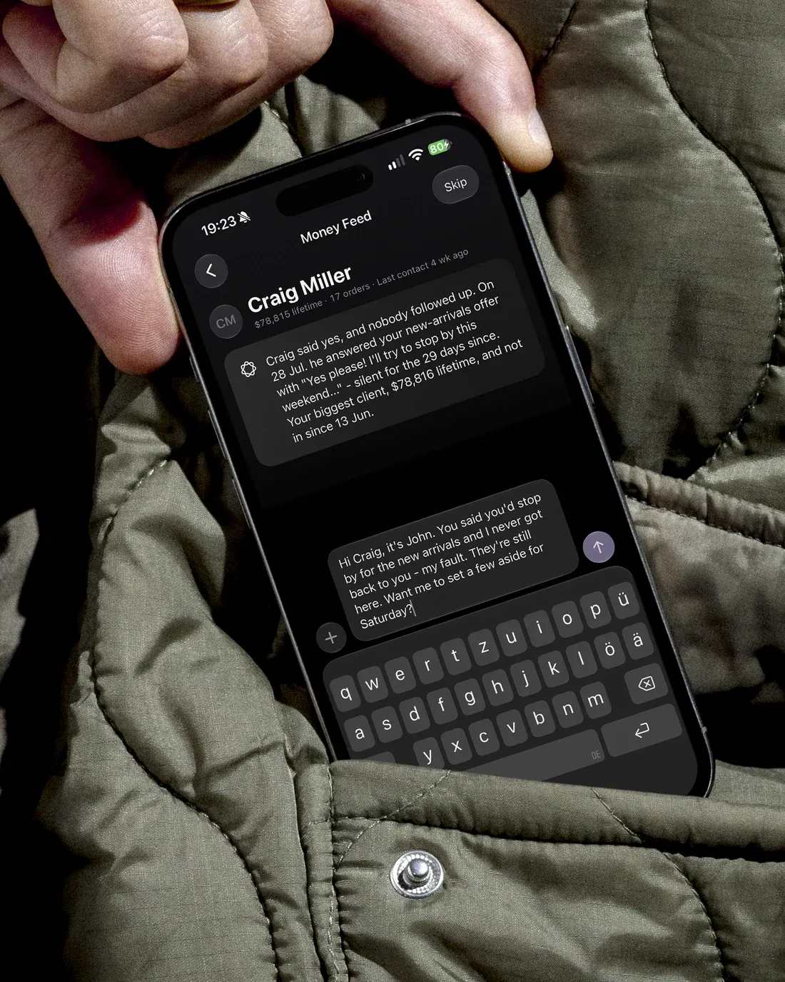 The Money Feed open on an iPhone, a drafted opener on screen and the keyboard up